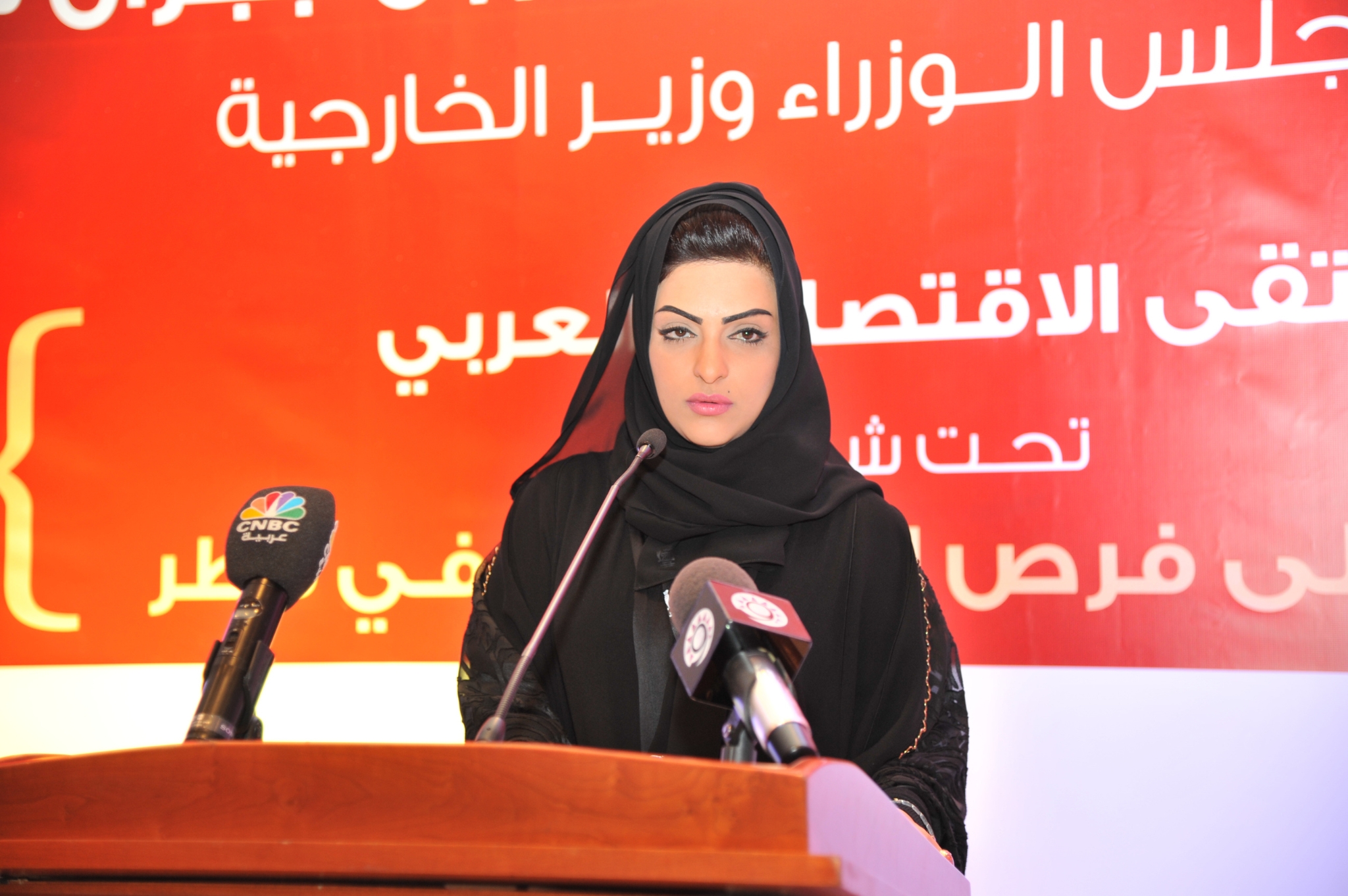 Curving forest road lined with tall pines.