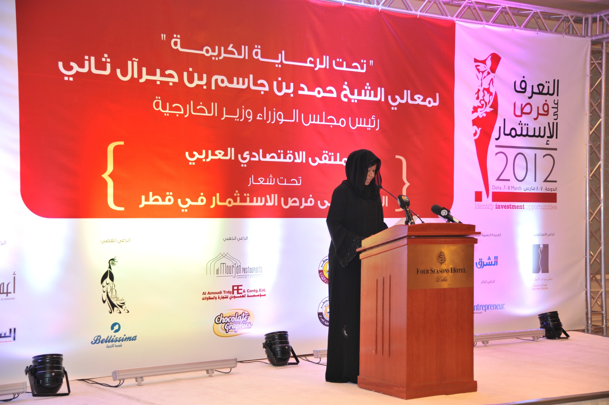 Curving forest road lined with tall pines.