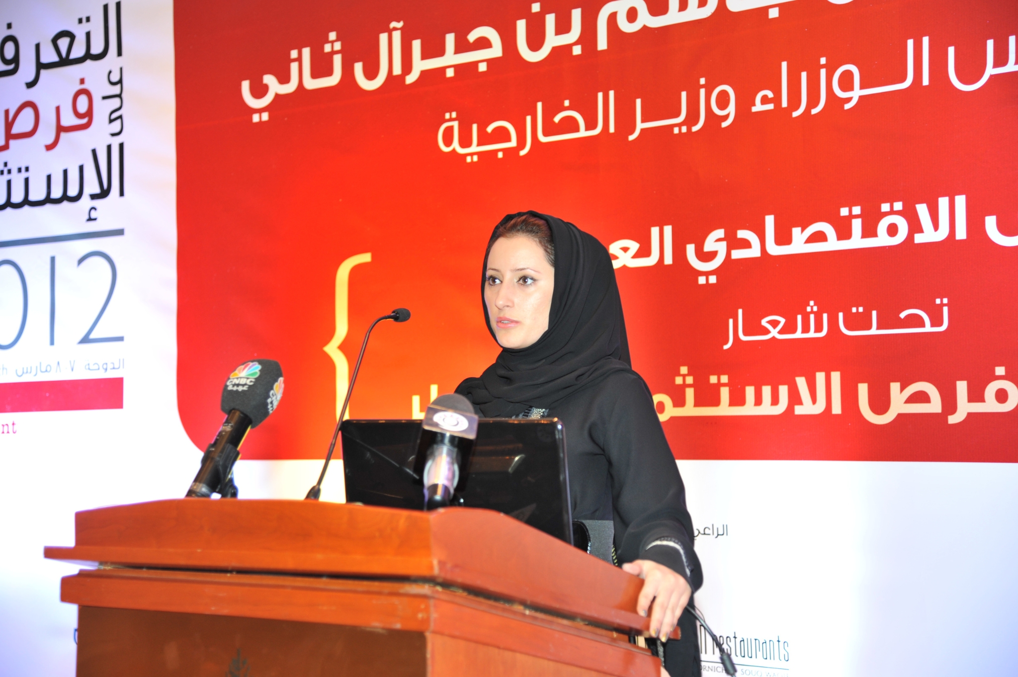 Curving forest road lined with tall pines.