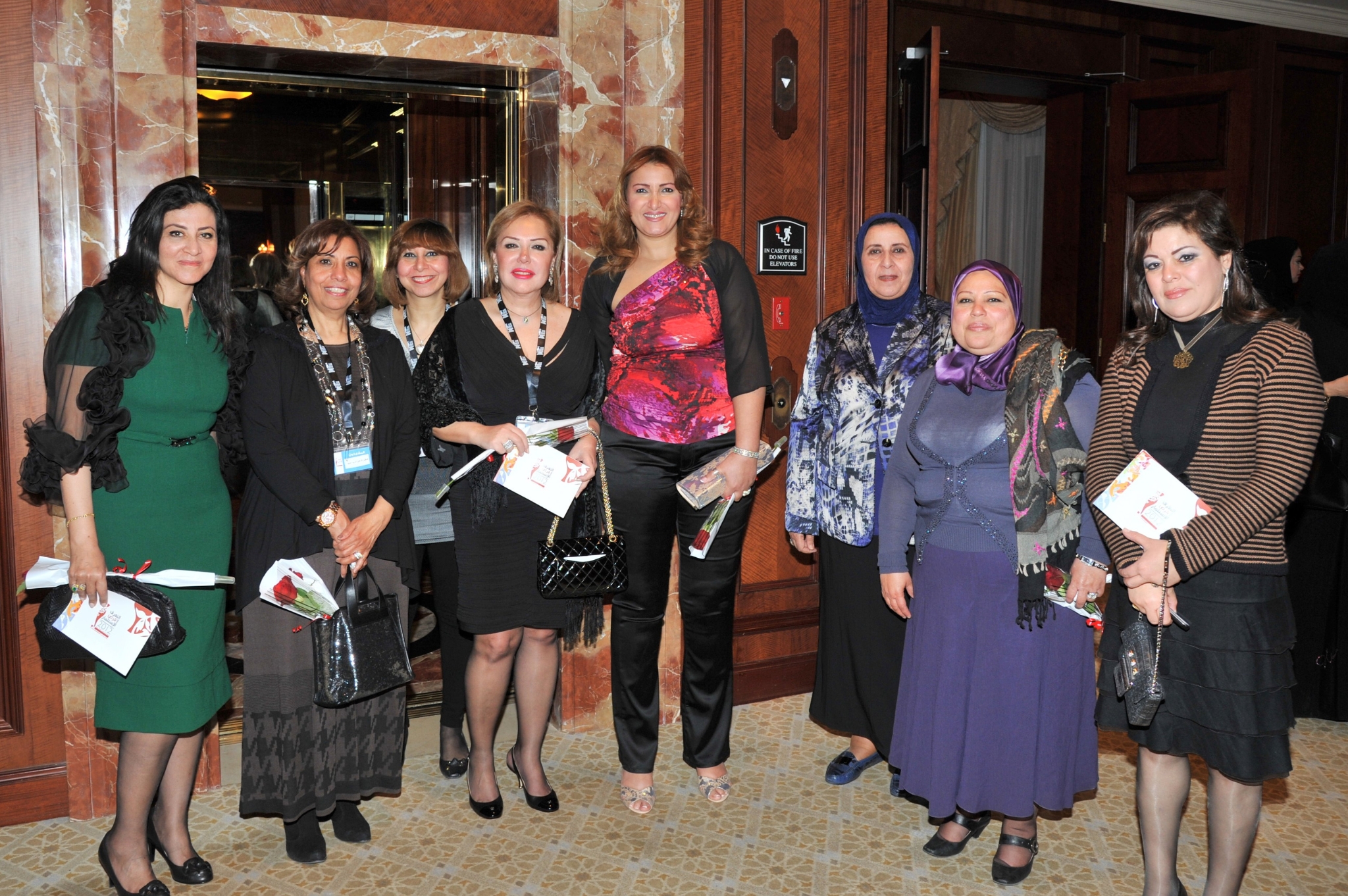 Curving forest road lined with tall pines.
