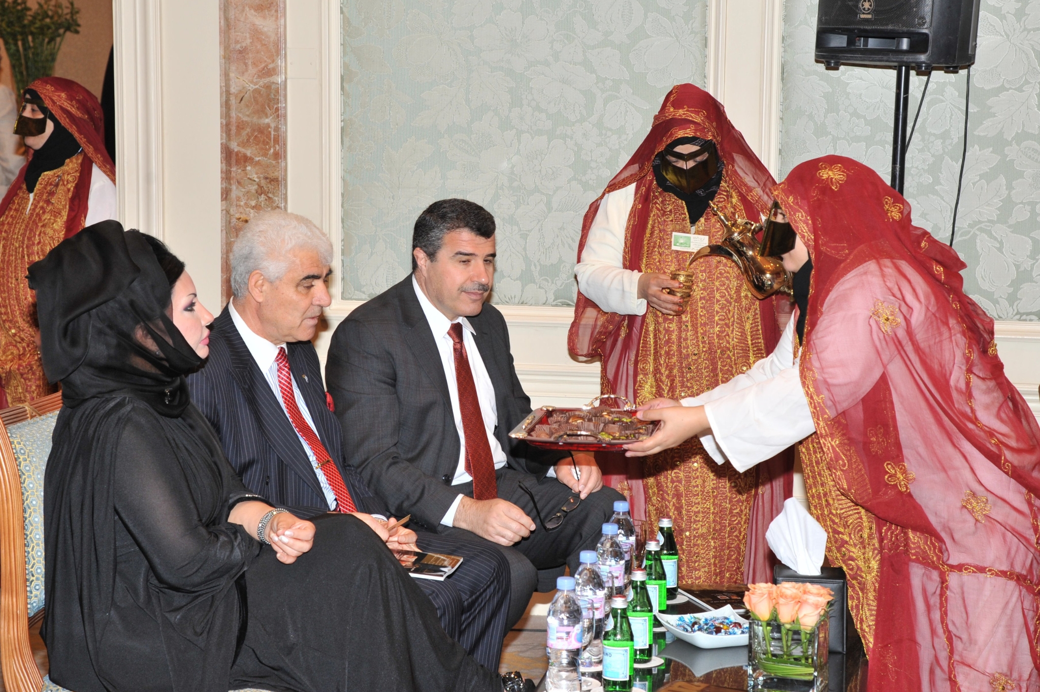 Curving forest road lined with tall pines.